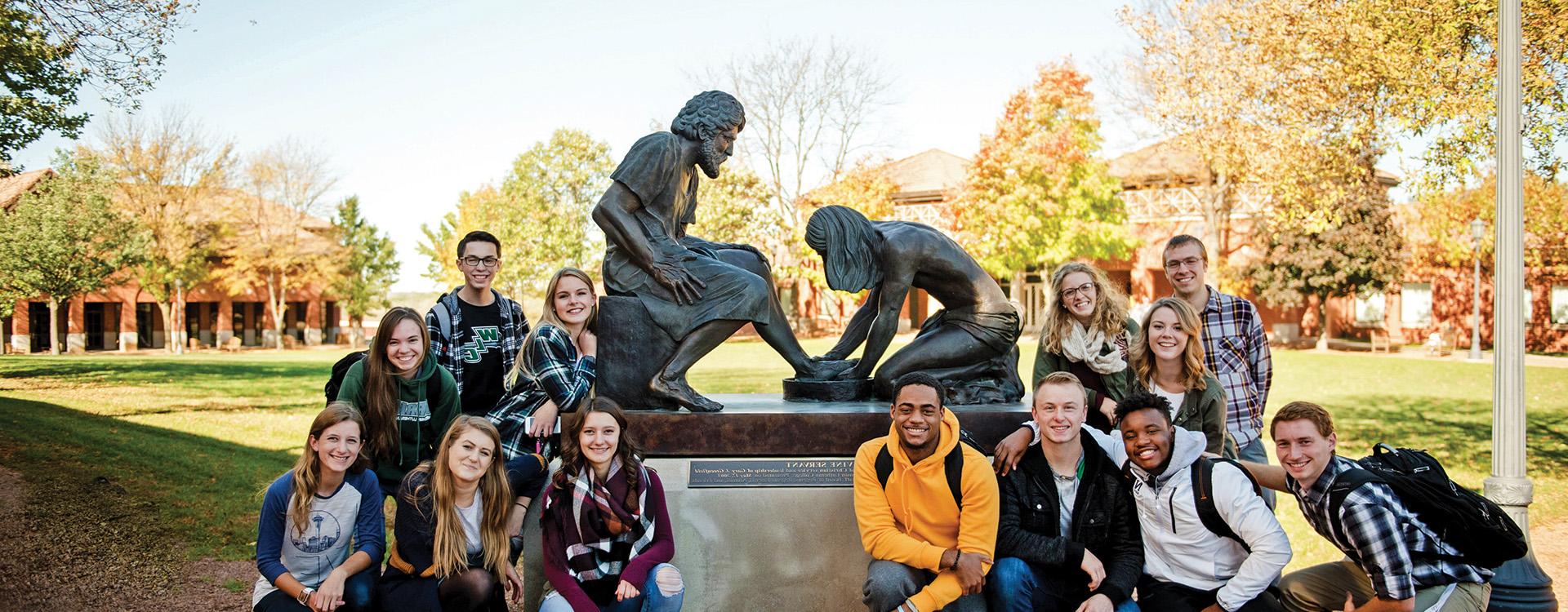 Group of WLC students near the Divine Servant Statue in the Quad
